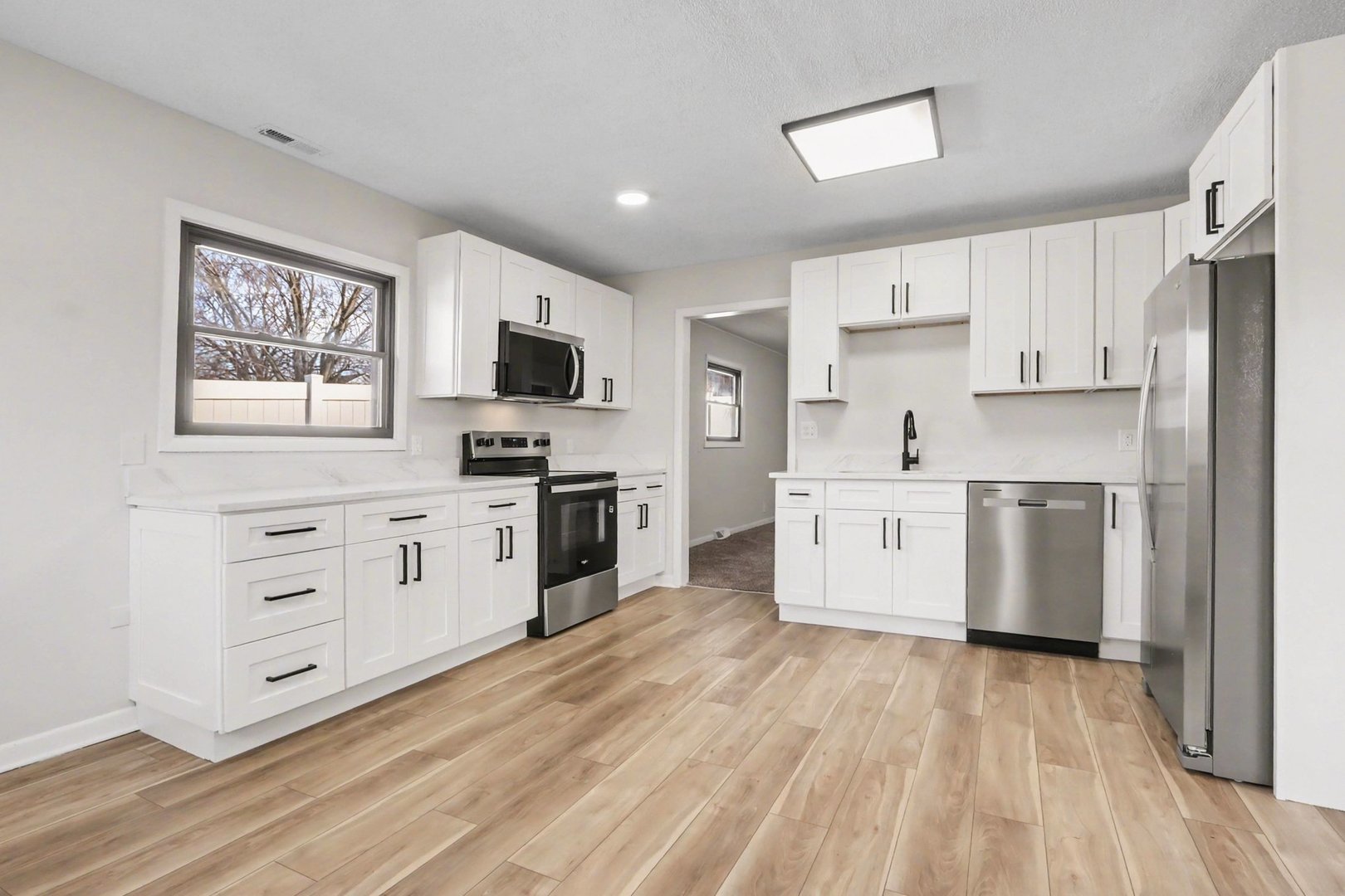 629 Thornton Street Lockport, IL 60441 - Photo 5 of 15 a kitchen with white cabinets stainless steel appliances and wooden floor