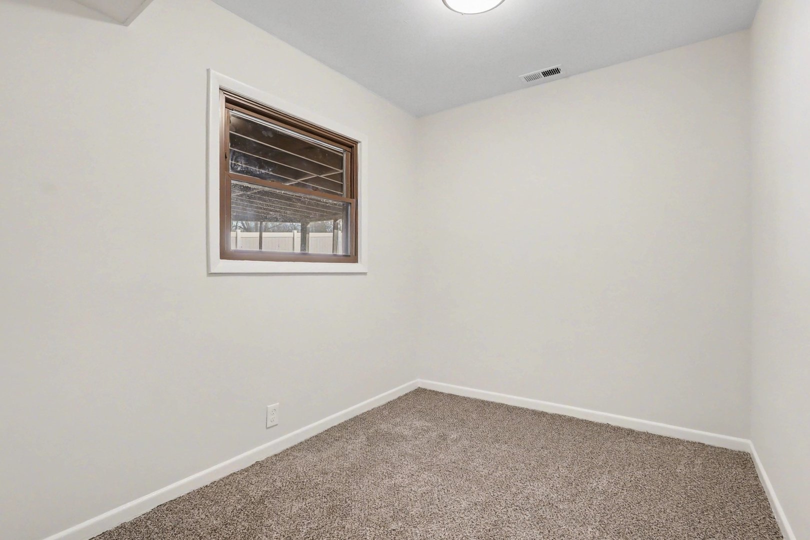 629 Thornton Street Lockport, IL 60441 - Photo 9 of 15 an empty room with a window