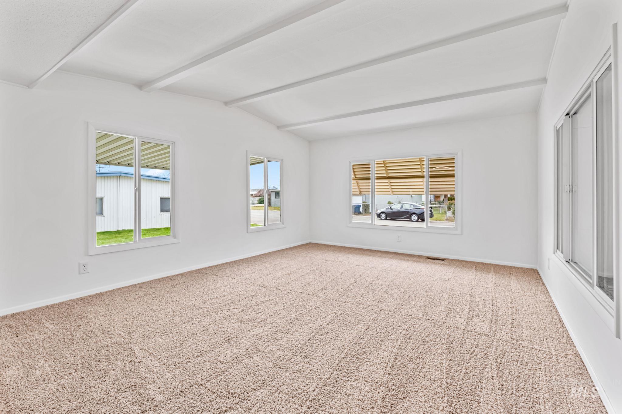 358 Bonanza Street Boise, ID 83713 - Photo 13 of 25 Carpeted empty room featuring plenty of natural light