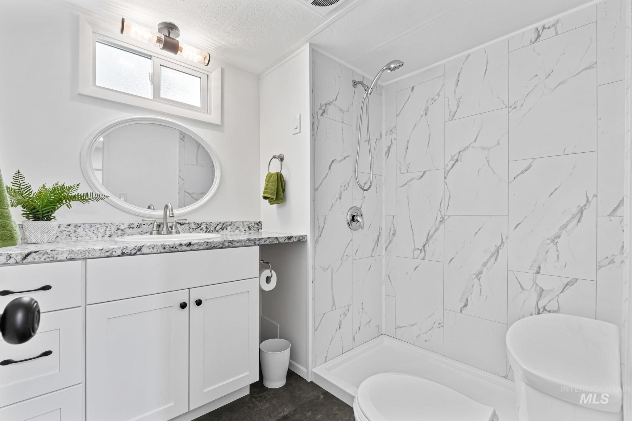 358 Bonanza Street Boise, ID 83713 - Photo 17 of 25 Full bath featuring vanity and a marble finish shower