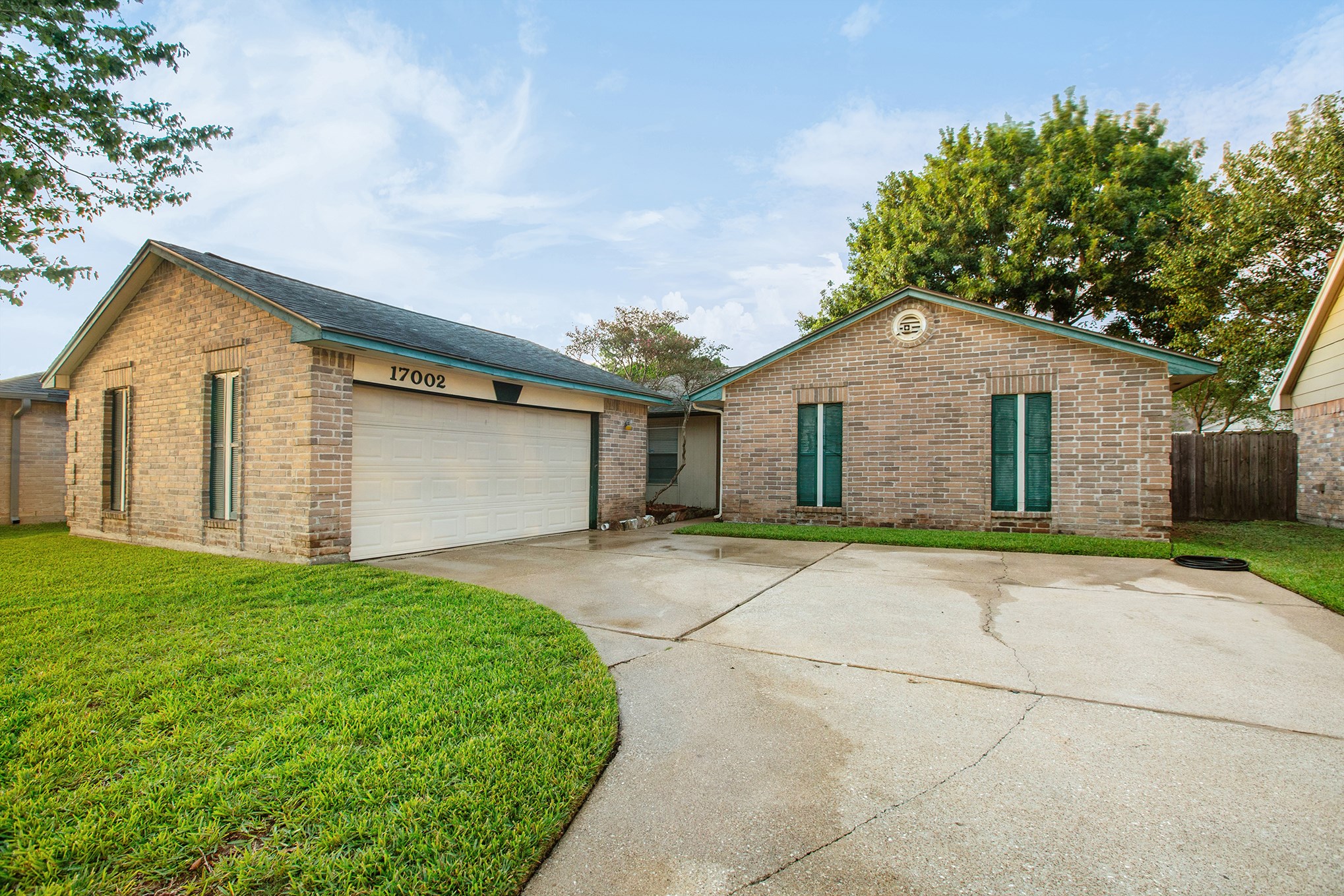 17002 Sky Blue Place Houston, TX 77095 - Photo 14 of 16 a front view of a house with a yard and garage