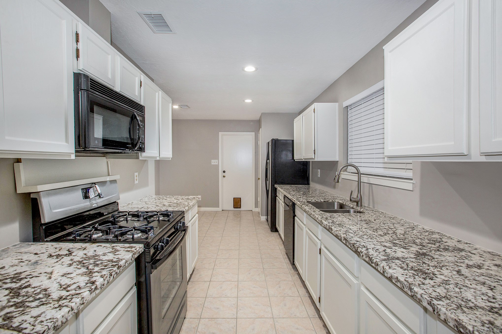 17002 Sky Blue Place Houston, TX 77095 - Photo 2 of 16 a large kitchen with a stove and a sink