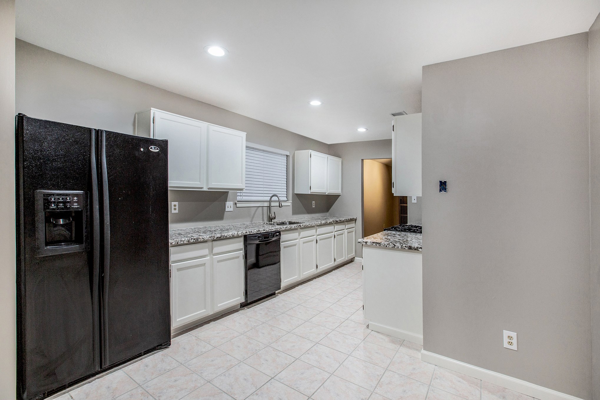 17002 Sky Blue Place Houston, TX 77095 - Photo 3 of 16 a kitchen with a refrigerator and a sink