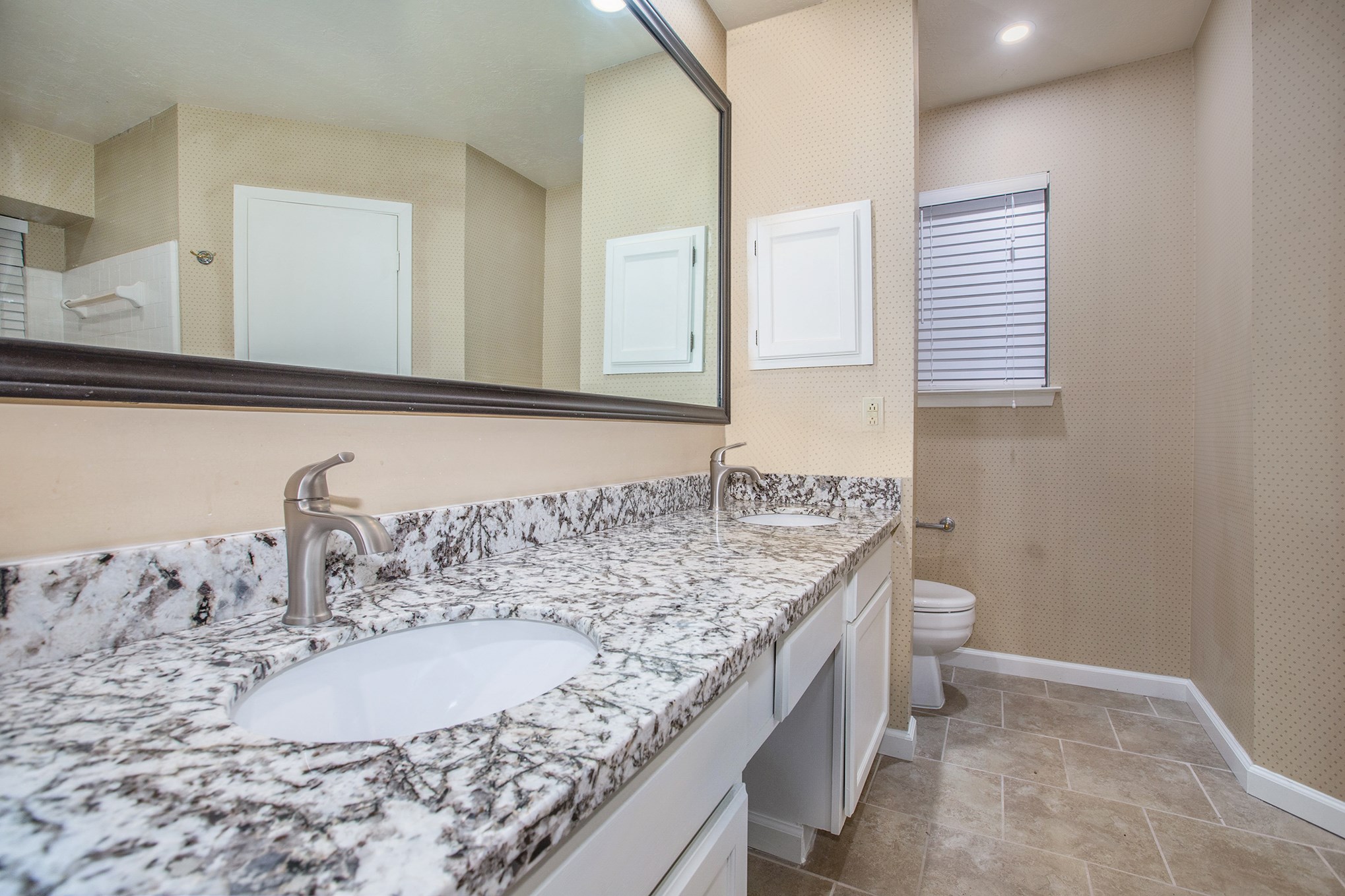 17002 Sky Blue Place Houston, TX 77095 - Photo 9 of 16 a bathroom with a granite countertop sink and a mirror