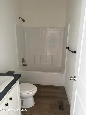a bathroom with a sink a toilet and bathtub