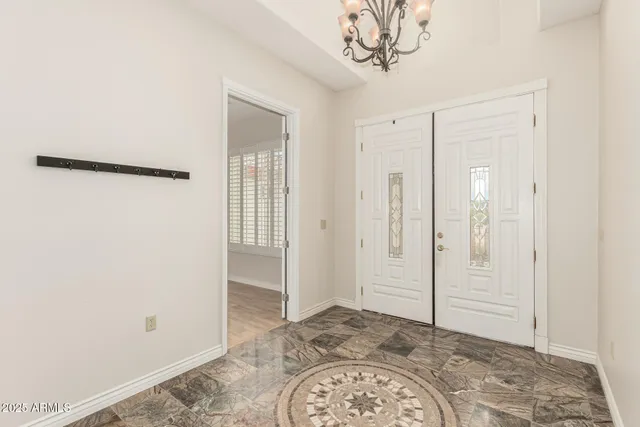 a view of an empty room and wooden floor