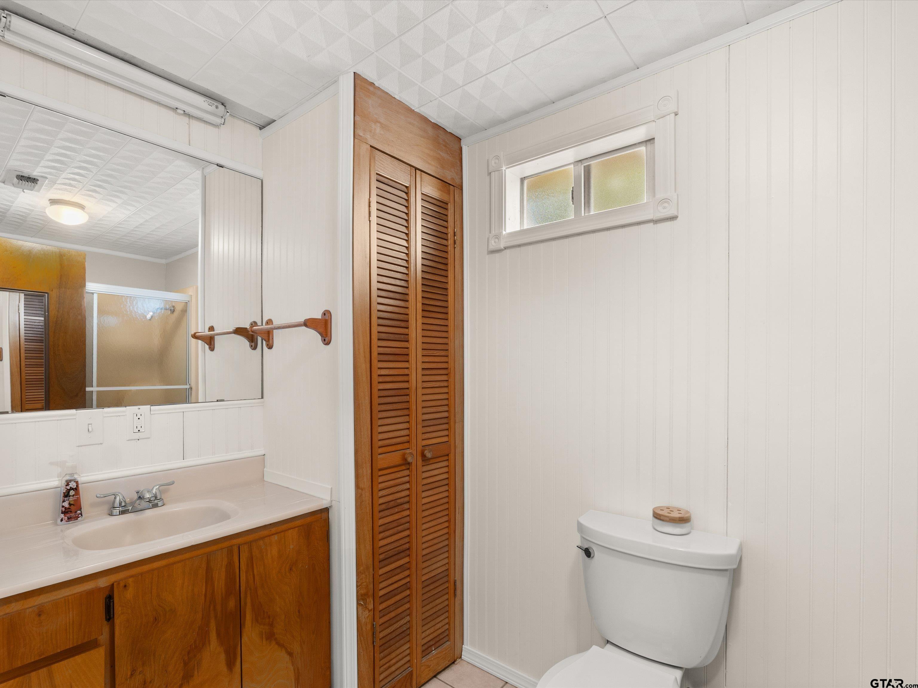 210 Gilbert Street Lone Star, TX 75668 - Photo 13 of 24 a bathroom with a granite countertop sink toilet and shower