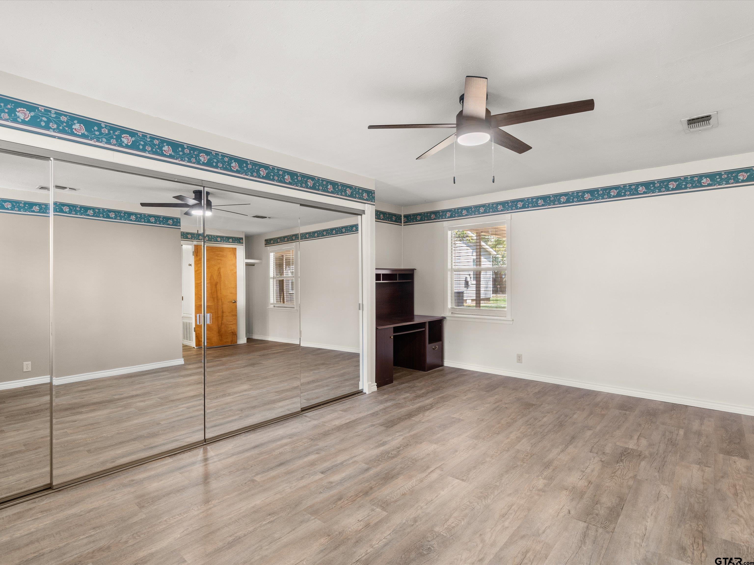 210 Gilbert Street Lone Star, TX 75668 - Photo 18 of 24 a view of empty room with wooden floor