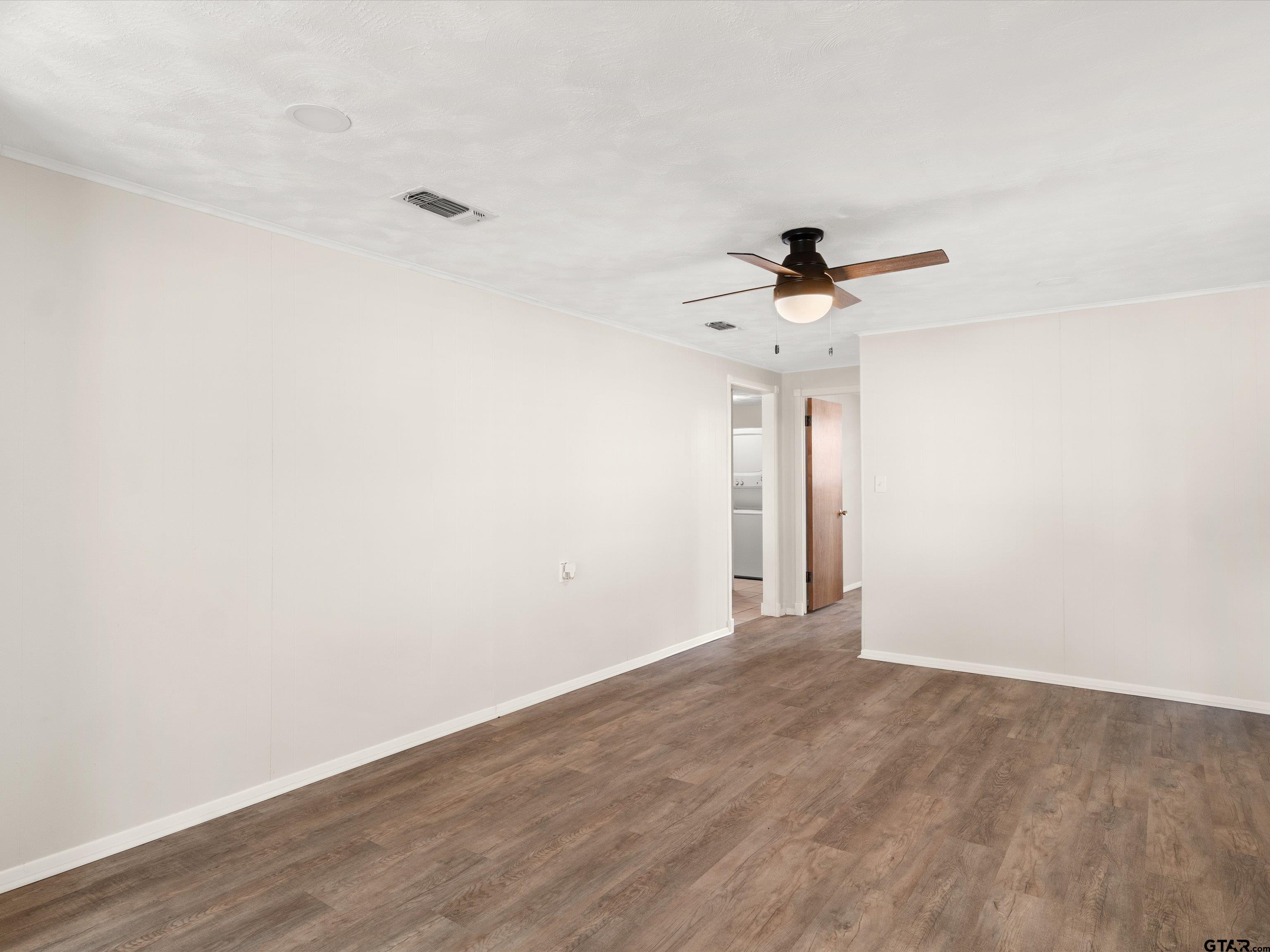 210 Gilbert Street Lone Star, TX 75668 - Photo 3 of 24 wooden floor in an empty room
