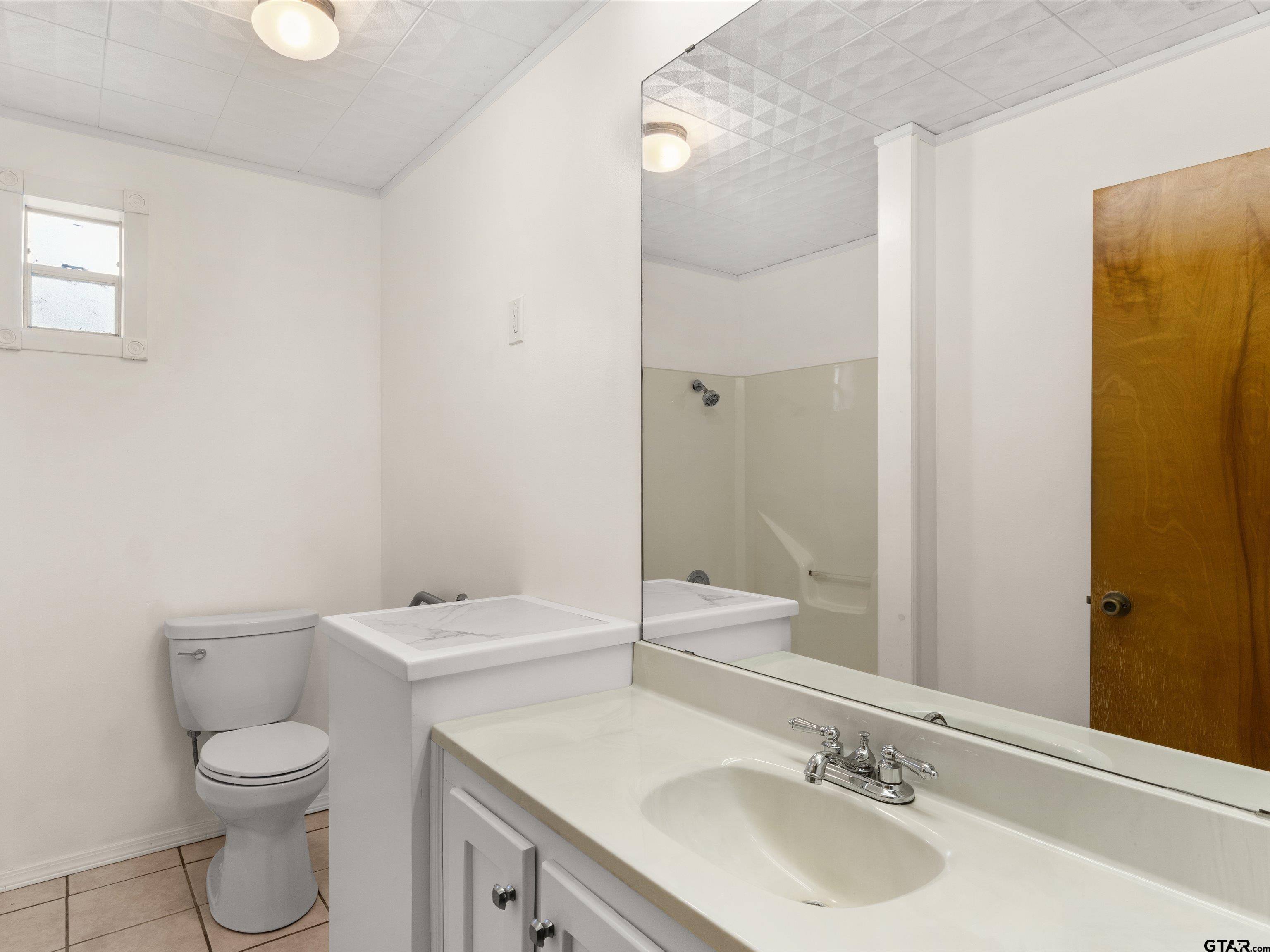 210 Gilbert Street Lone Star, TX 75668 - Photo 5 of 24 a bathroom with a sink toilet and shower