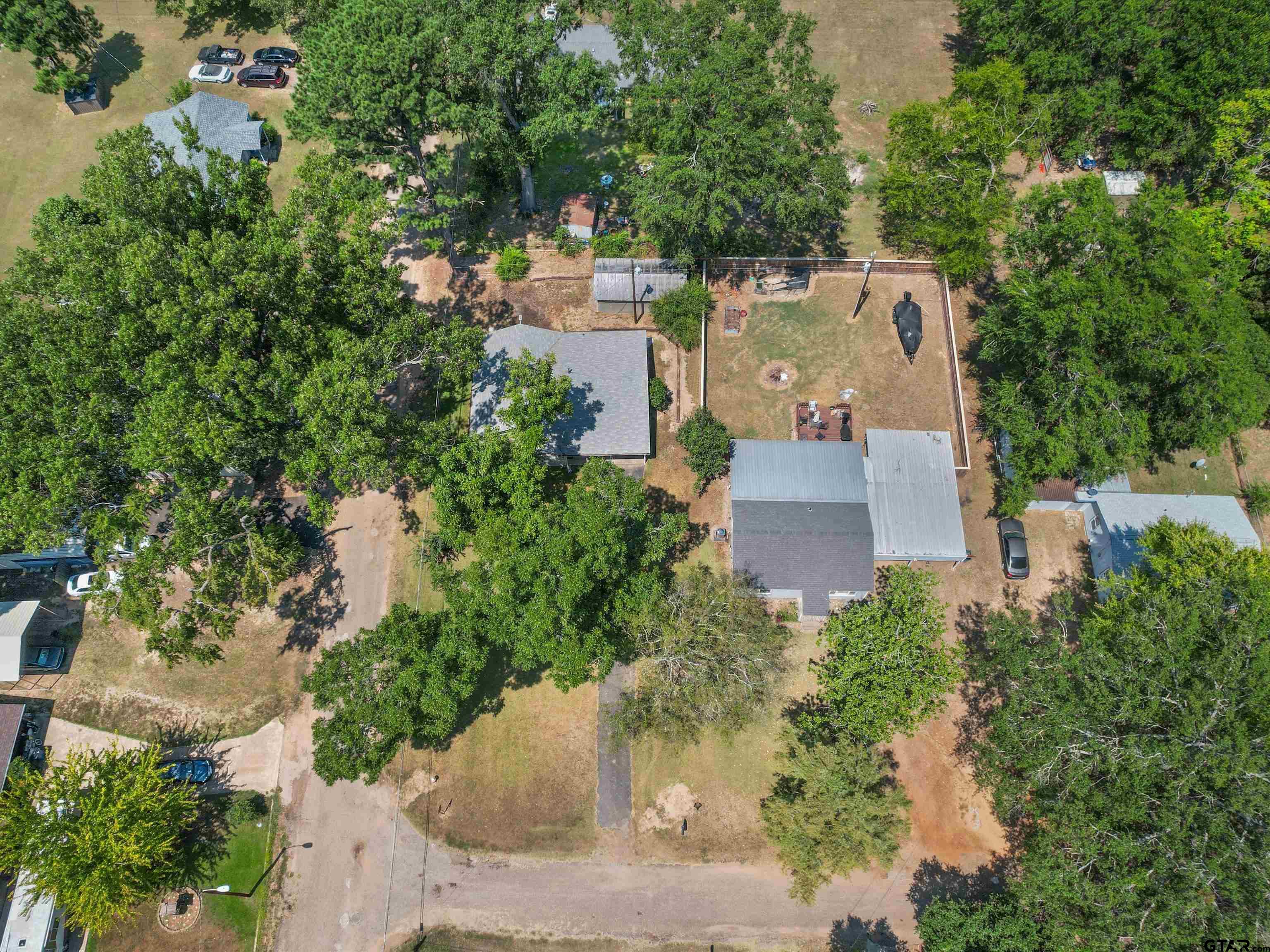 210 Gilbert Street Lone Star, TX 75668 - Photo 8 of 24 an aerial view of a house with a yard and garden