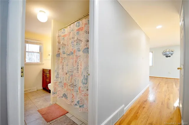 a view of a bathroom with a tub and shower curtain