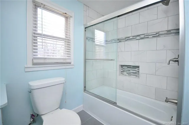 a bathroom with a toilet and a shower