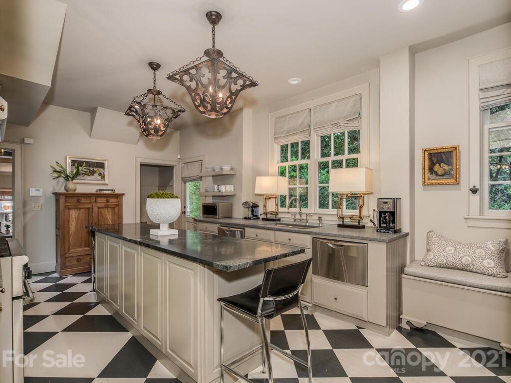 2001 Queens Road East Charlotte, NC 28207 - Photo 12 of 39 a kitchen with stainless steel appliances kitchen island granite countertop a sink and a refrigerator