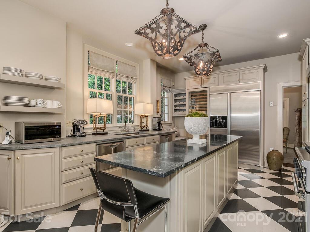 2001 Queens Road East Charlotte, NC 28207 - Photo 14 of 39 a kitchen with a counter space a sink stainless steel appliances and cabinets