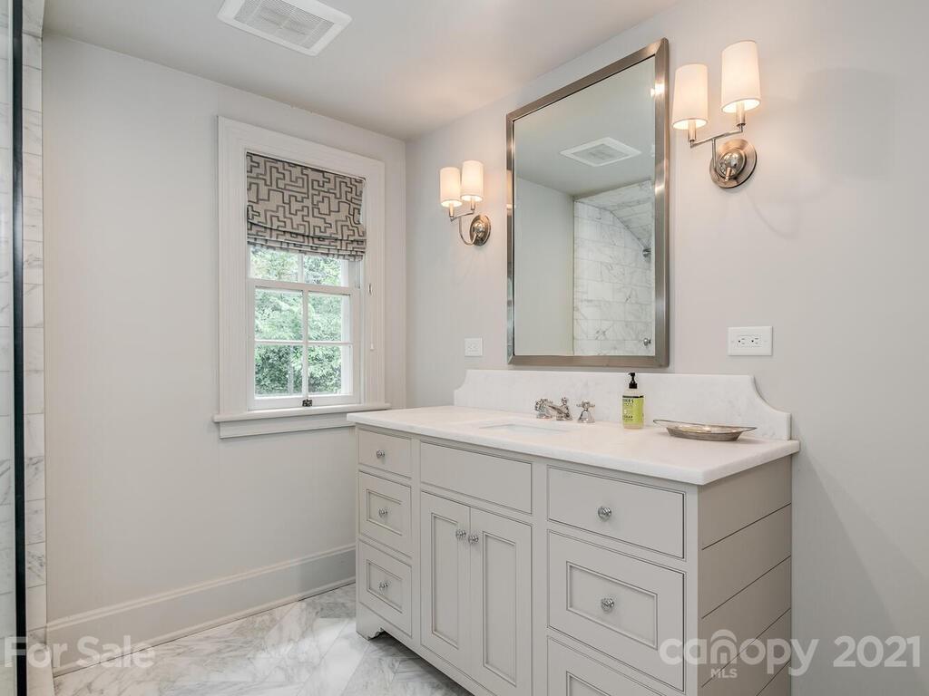 2001 Queens Road East Charlotte, NC 28207 - Photo 22 of 39 a bathroom with a sink and a mirror