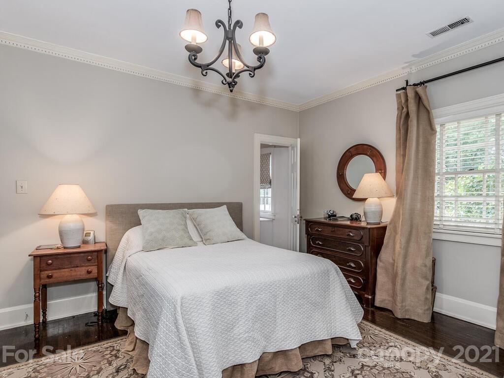 2001 Queens Road East Charlotte, NC 28207 - Photo 26 of 39 a bedroom with a bed and a chandelier