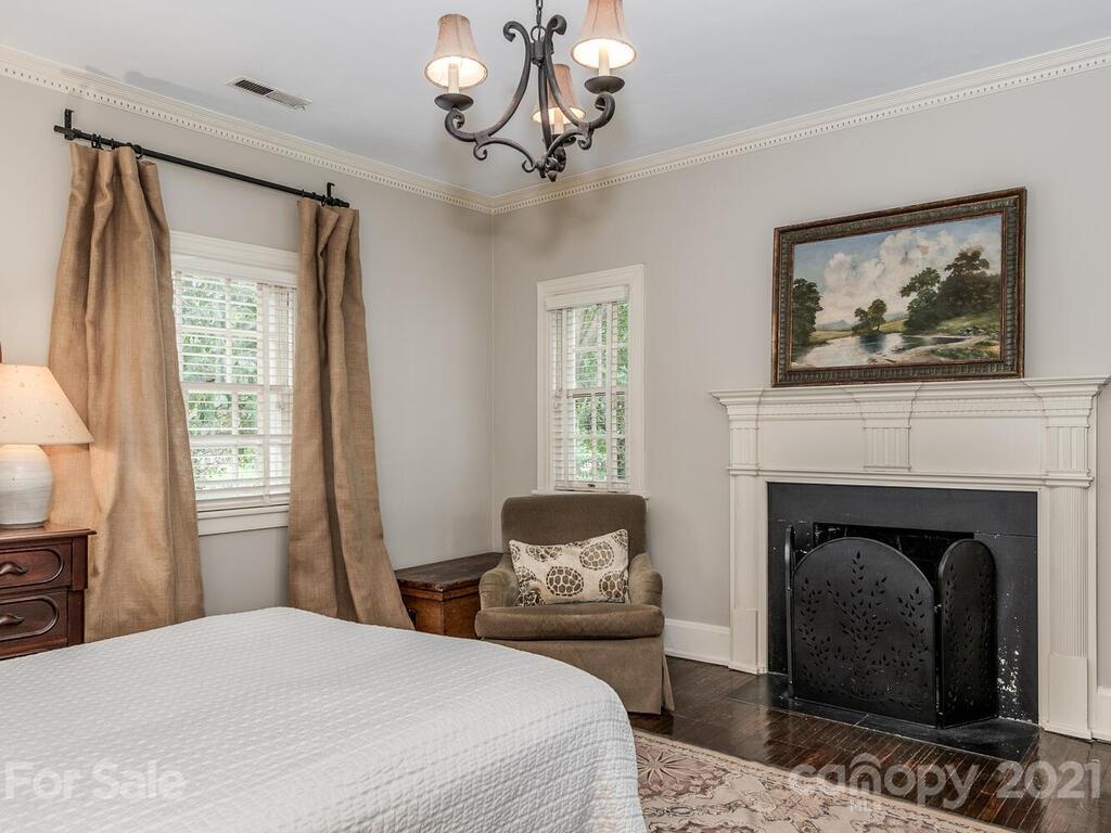 2001 Queens Road East Charlotte, NC 28207 - Photo 27 of 39 a bedroom with a bed and a fireplace