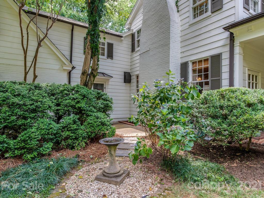 2001 Queens Road East Charlotte, NC 28207 - Photo 32 of 39 a view of a backyard with plants and a fountain
