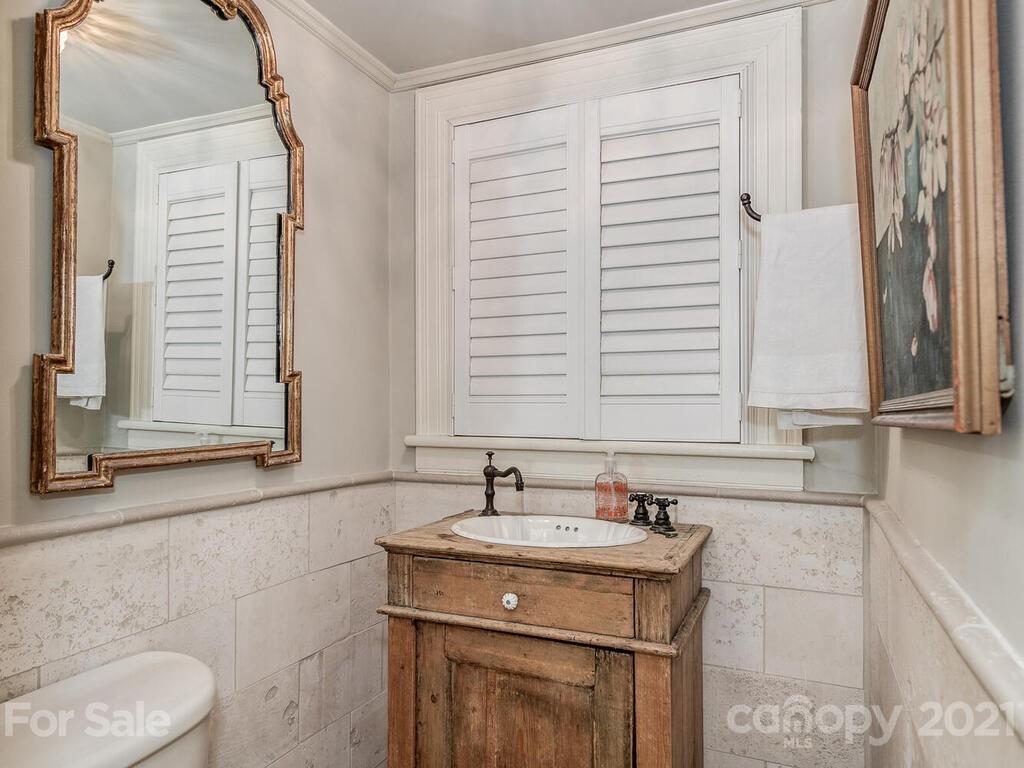 2001 Queens Road East Charlotte, NC 28207 - Photo 9 of 39 a bathroom with a granite countertop sink and a mirror