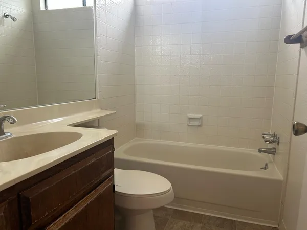 a bathroom with a sink a toilet and bathtub