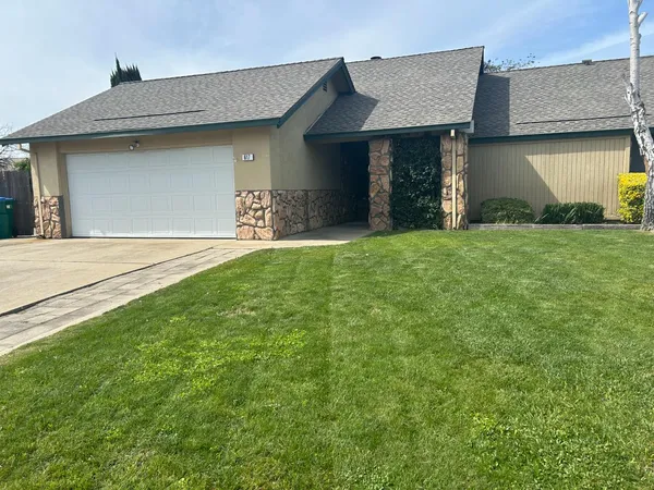 a front view of a house with a yard and garage