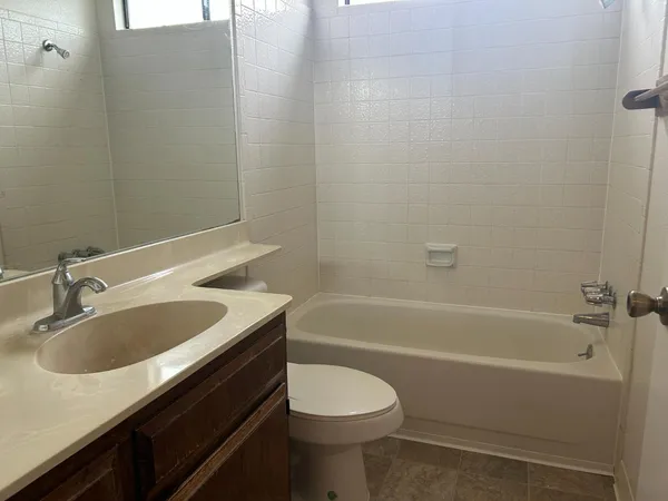 a spacious bathroom with a sink and a mirror