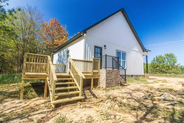 a view of balcony with wooden floor and fence