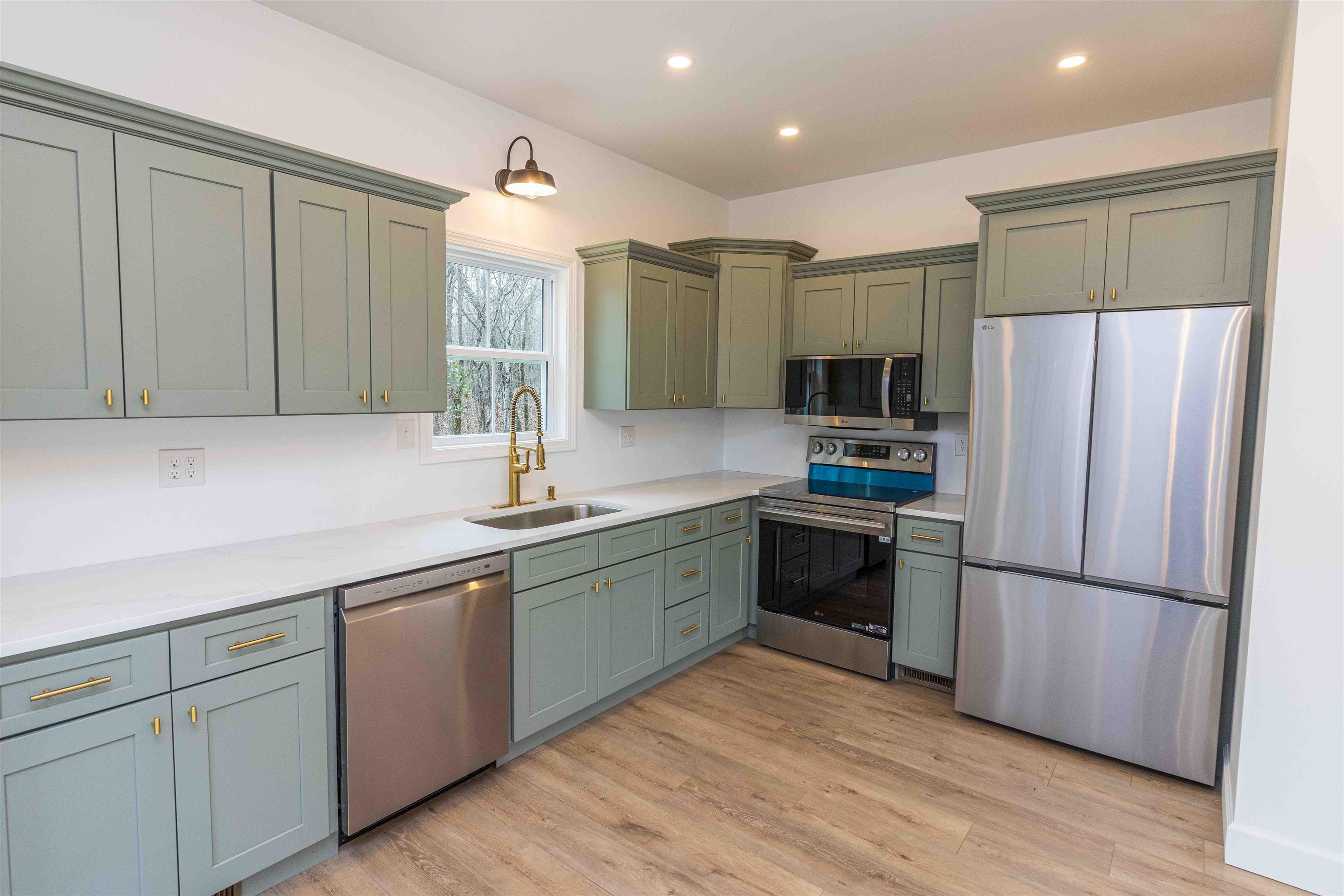 775 Airport Road Selmer, TN 38375 - Photo 10 of 20 a kitchen with granite countertop stainless steel appliances and wooden cabinets