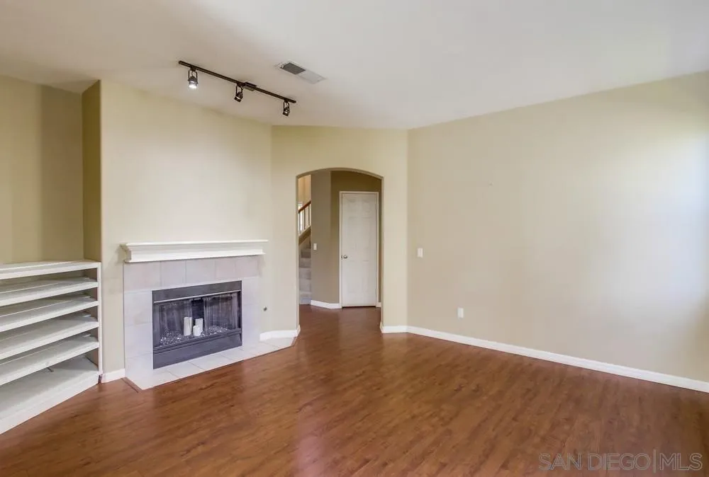 11440 Village Ridge Road San Diego, CA 92131 - Photo 11 of 52 a view of empty room with wooden floor and fireplace