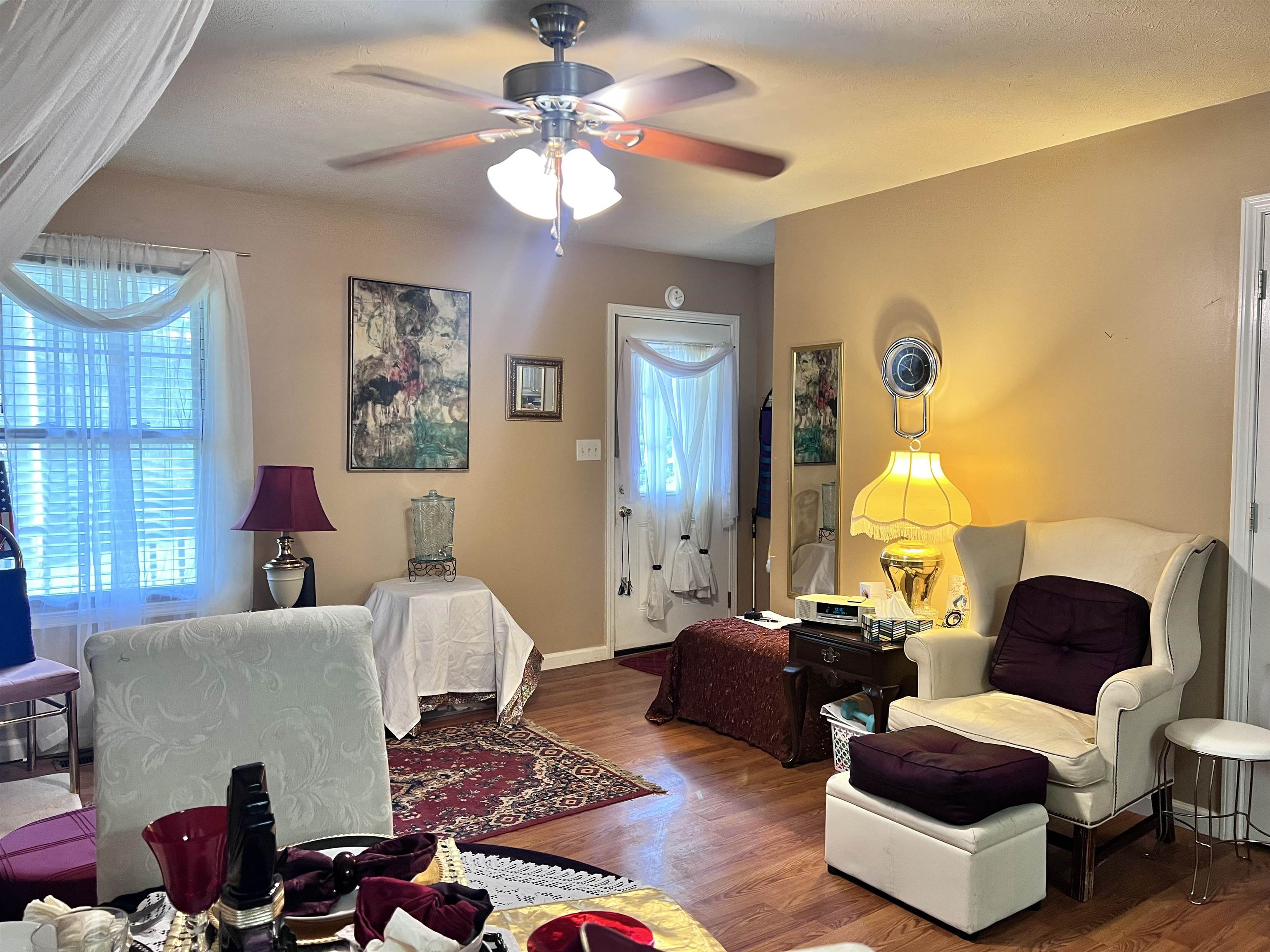 3800 County Home Road Savannah, TN 38372 - Photo 8 of 21 Living room featuring wood finished floors, healthy amount of natural light, and a ceiling fan
