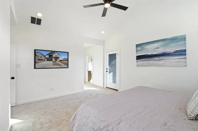 a bedroom with a bed and a painting on the wall