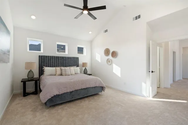 a spacious bedroom with a bed and a window