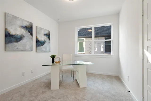 a dining room with a table and windows