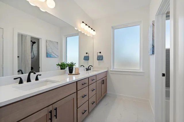 a bathroom with a double vanity sink and mirror