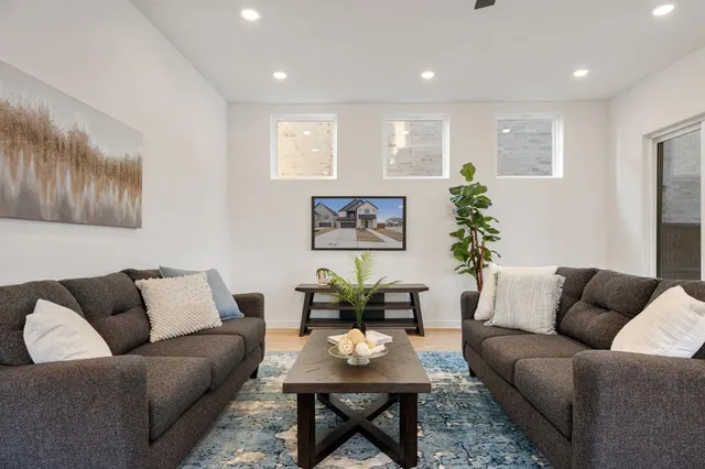 a living room with furniture potted plant and a window