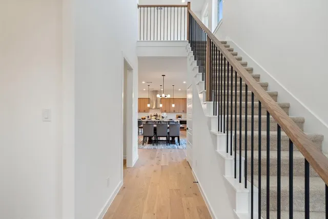 a view of entryway and hall with wooden floor
