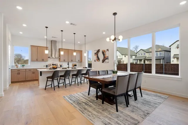 a large kitchen with a table and chairs