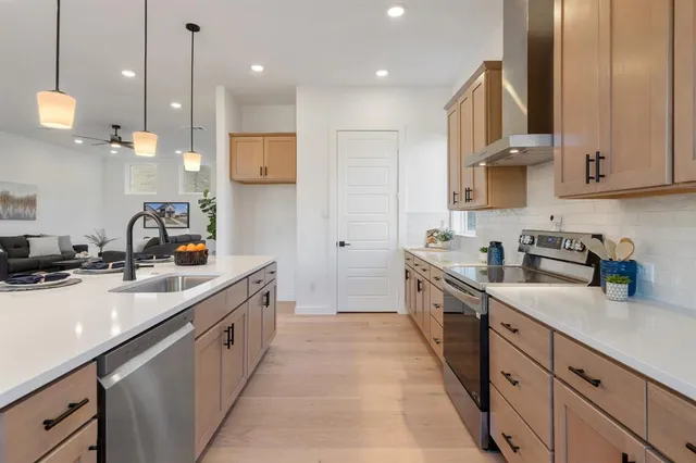 a large kitchen with stainless steel appliances lots of counter space sink and cabinets