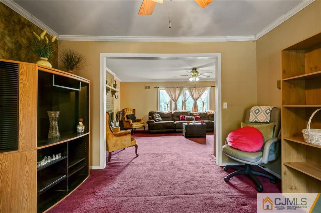 22 Cottrell Road Old Bridge, NJ 07747 - Photo 16 of 32 a living room with furniture a flat screen tv and a floor to ceiling window