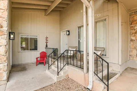 a view of a balcony with table and chairs