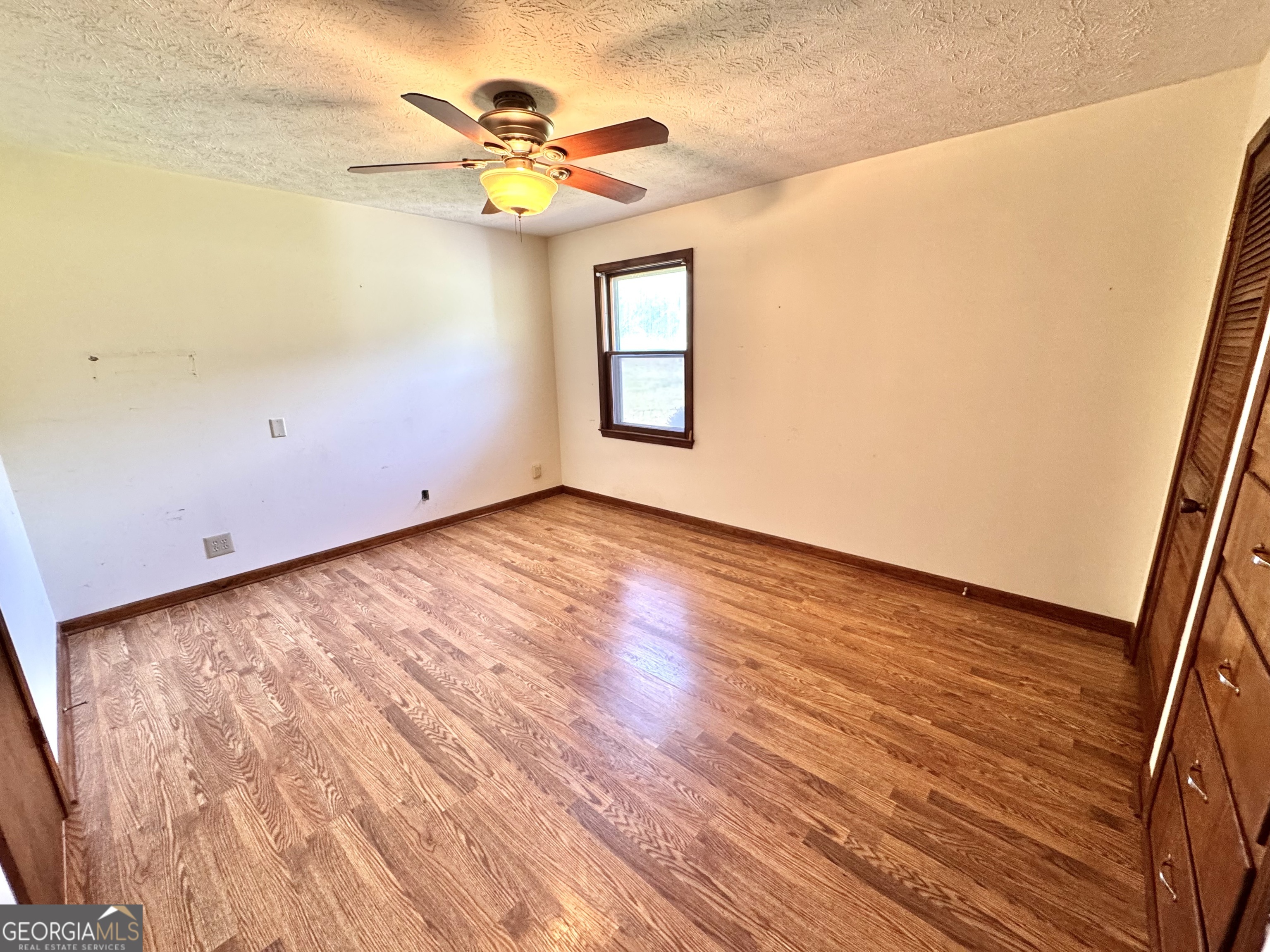 1760 Fears Road Rutledge, GA 30663 - Photo 23 of 68 a view of an empty room with a window and wooden floor