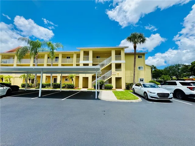 a view of a building with car parked