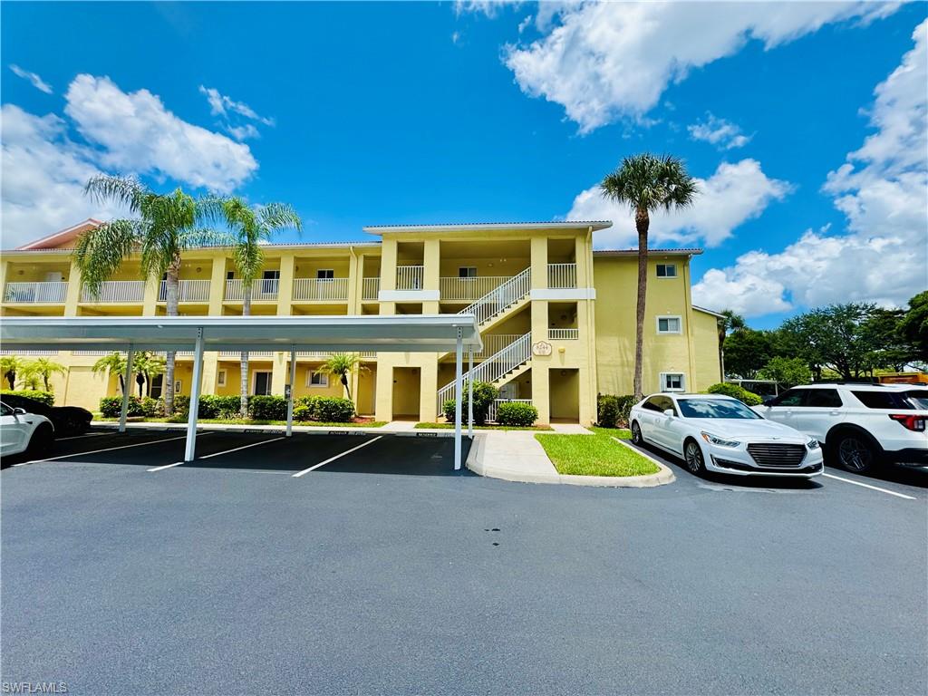 a view of a building with car parked