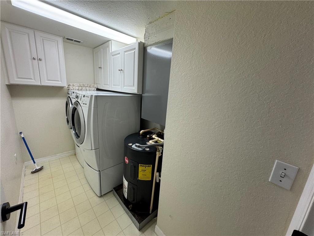 8244 Key Royal Circle, Unit 633 Naples, FL 34119 - Photo 13 of 28 a storage room with washer and dryer