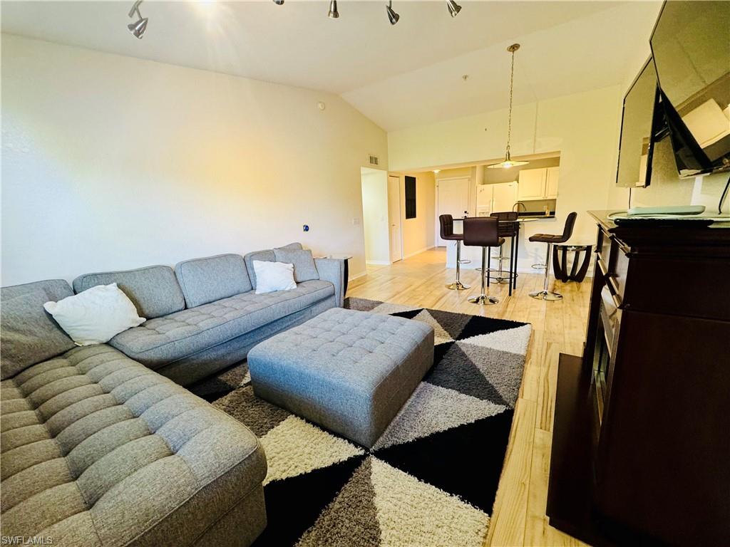 8244 Key Royal Circle, Unit 633 Naples, FL 34119 - Photo 14 of 28 a living room with furniture and a table