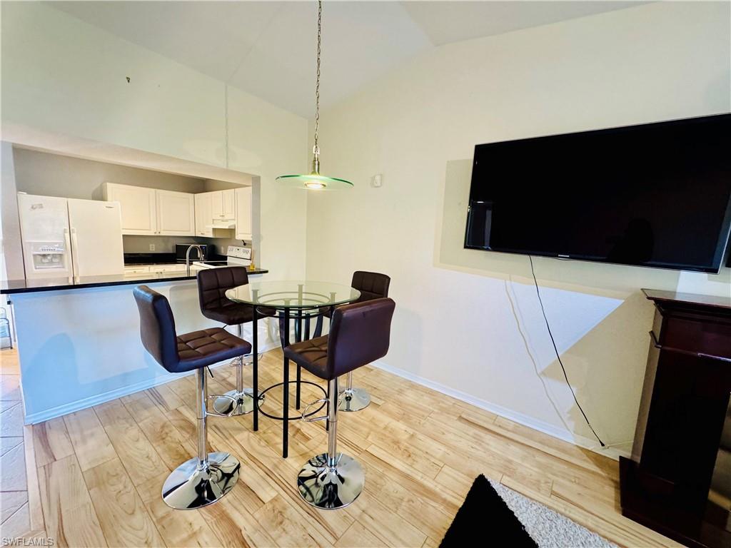 8244 Key Royal Circle, Unit 633 Naples, FL 34119 - Photo 15 of 28 a living room with furniture and a flat screen tv