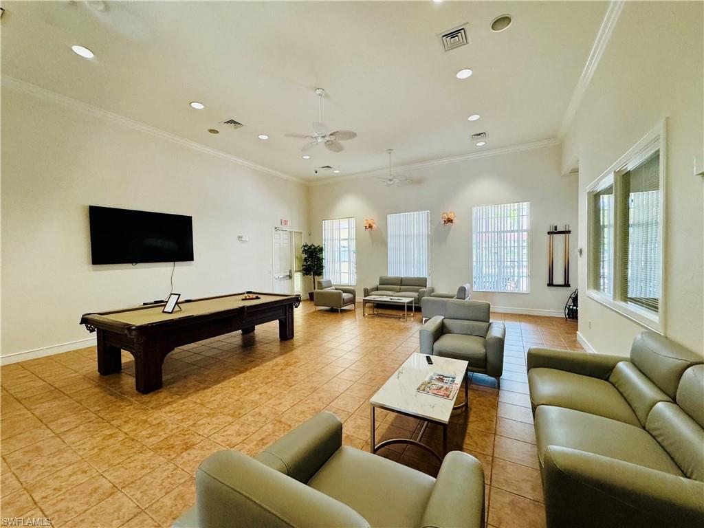 8244 Key Royal Circle, Unit 633 Naples, FL 34119 - Photo 16 of 28 a living room with furniture and a flat screen tv