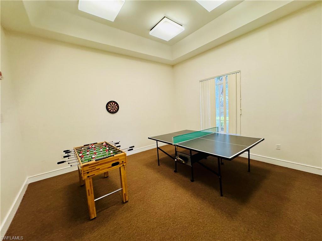 8244 Key Royal Circle, Unit 633 Naples, FL 34119 - Photo 18 of 28 a room with table chairs and a potted plant