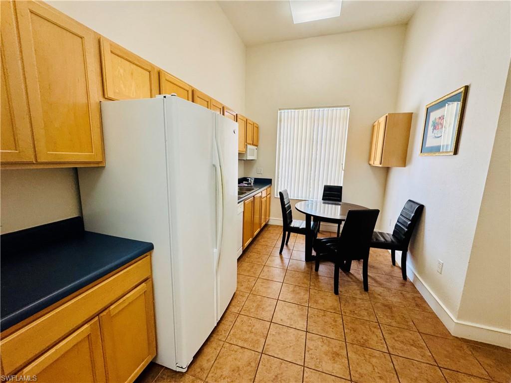 8244 Key Royal Circle, Unit 633 Naples, FL 34119 - Photo 20 of 28 a dining room with furniture and a window